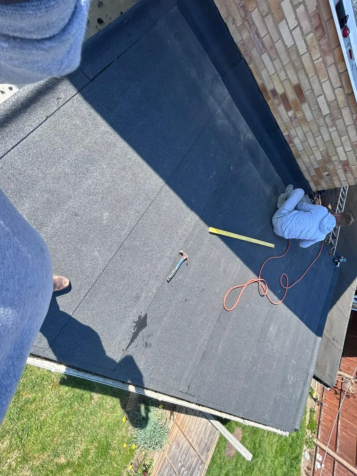 Roofer working on a flat roof installation or repair